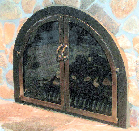 Osterville Bee Hive Arch  Black finish frame, dark antique brass twin doors standard forged handles, and smoke glass. No mesh, no draft panel.